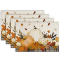 Stack of beige autumn placemats with pumpkins, flowers, and leaf print