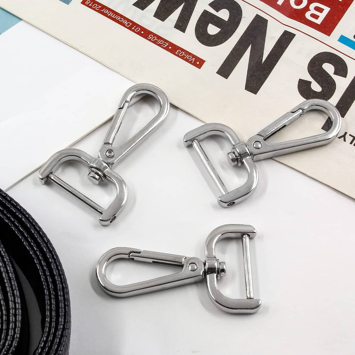 Silver swivel snap hook clasps attached to straps for bag or lanyard