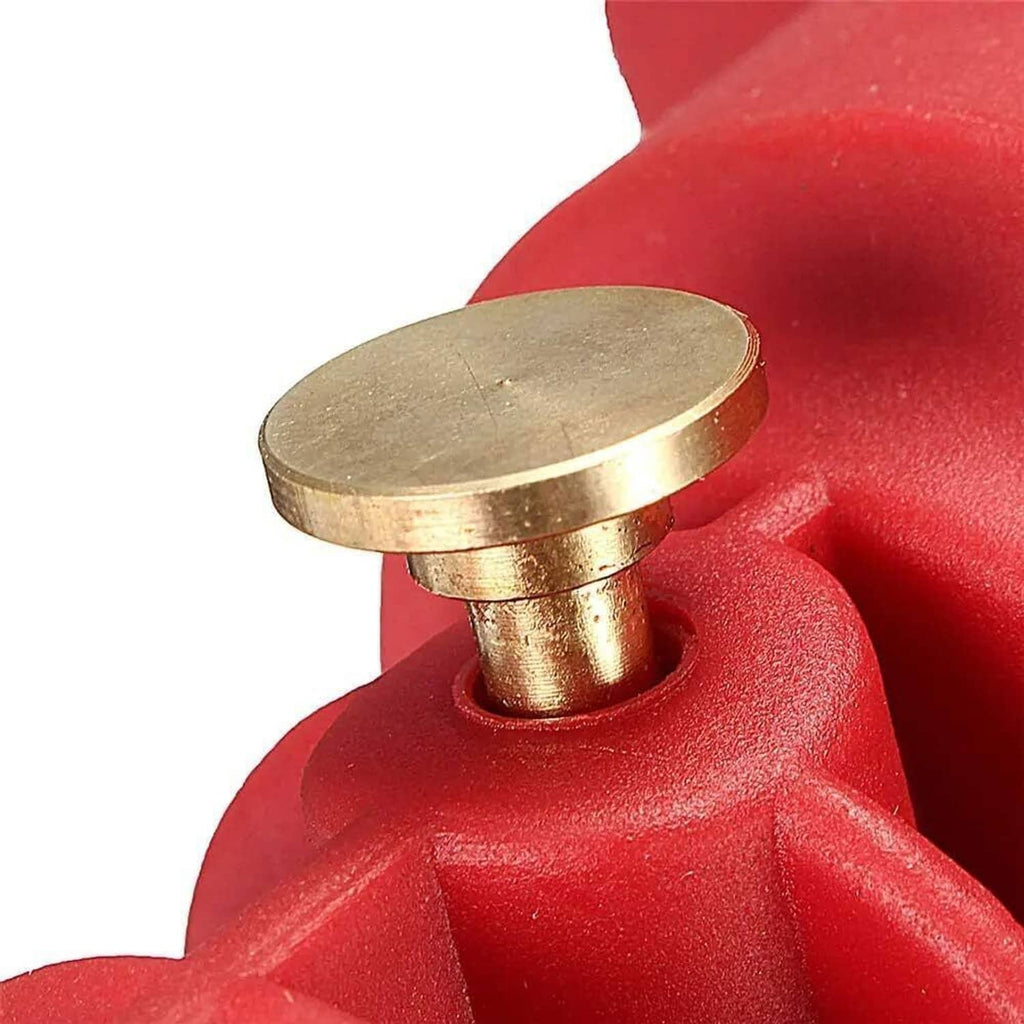 Brass-tipped pneumatic boot expander nozzle on red tool housing