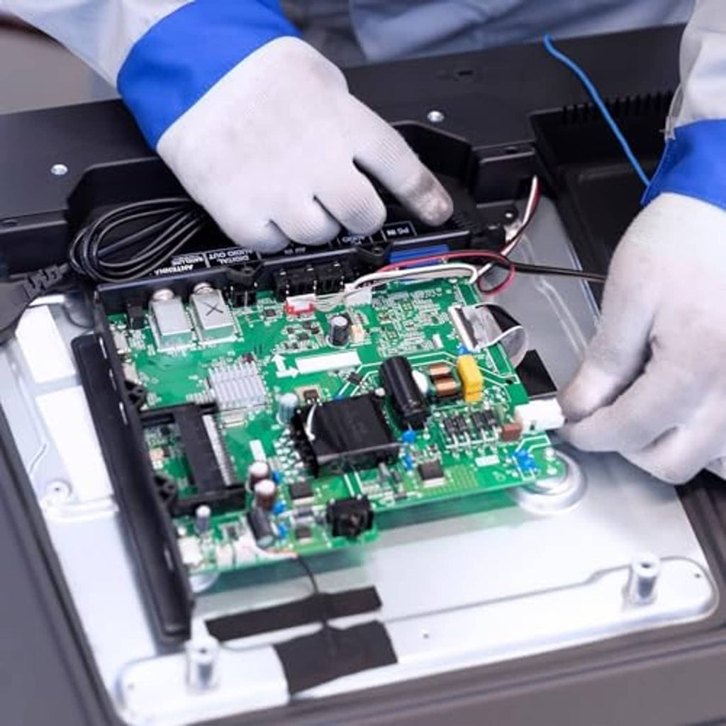 Multiturn trimmer potentiometer components on a green circuit board during assembly