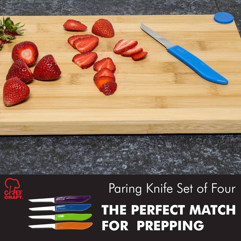 Paring knife on wooden cutting board with sliced strawberries