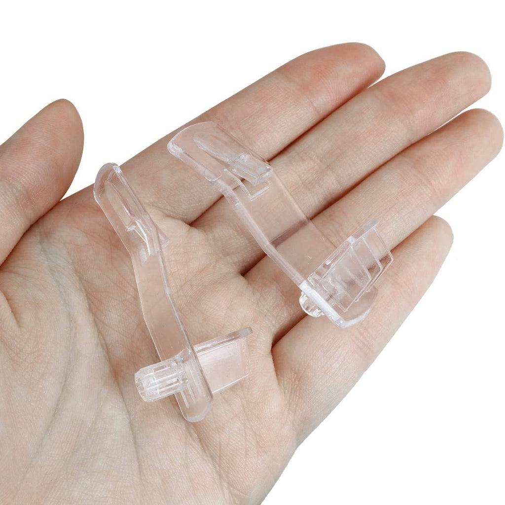 Clear plastic shelf support pegs held in hand, showing small locking pins