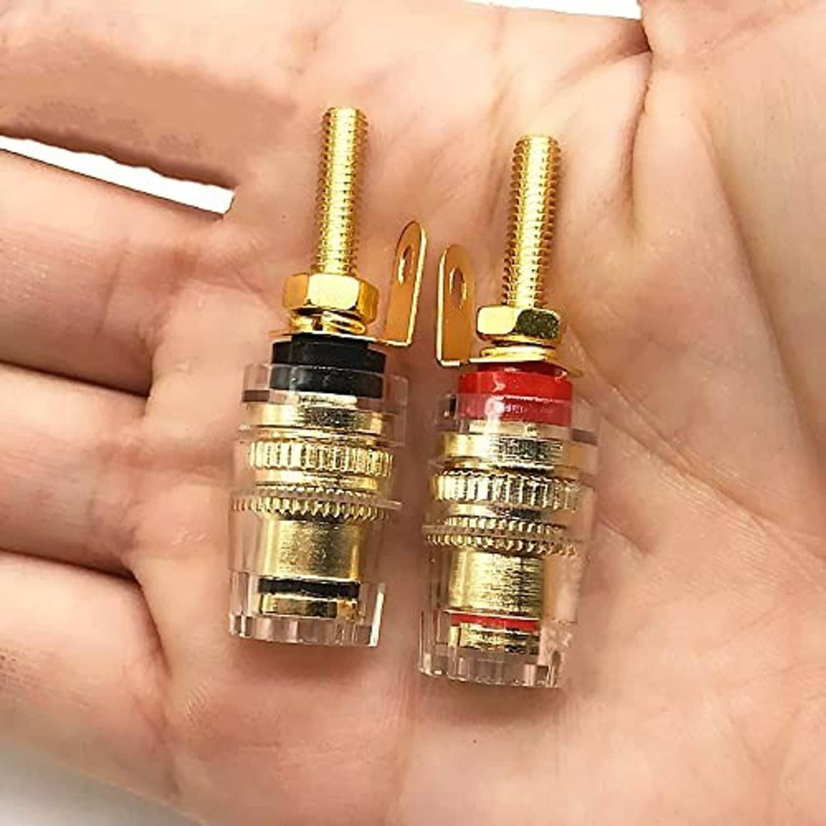 Gold plated banana plug binding posts on hand, black and red insulators
