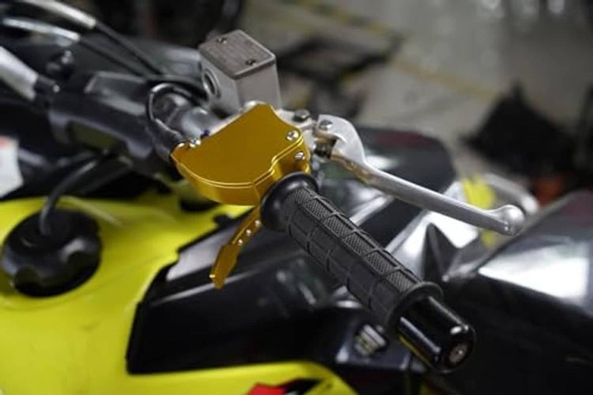Gold thumb throttle with black grip and mounted handlebar housing