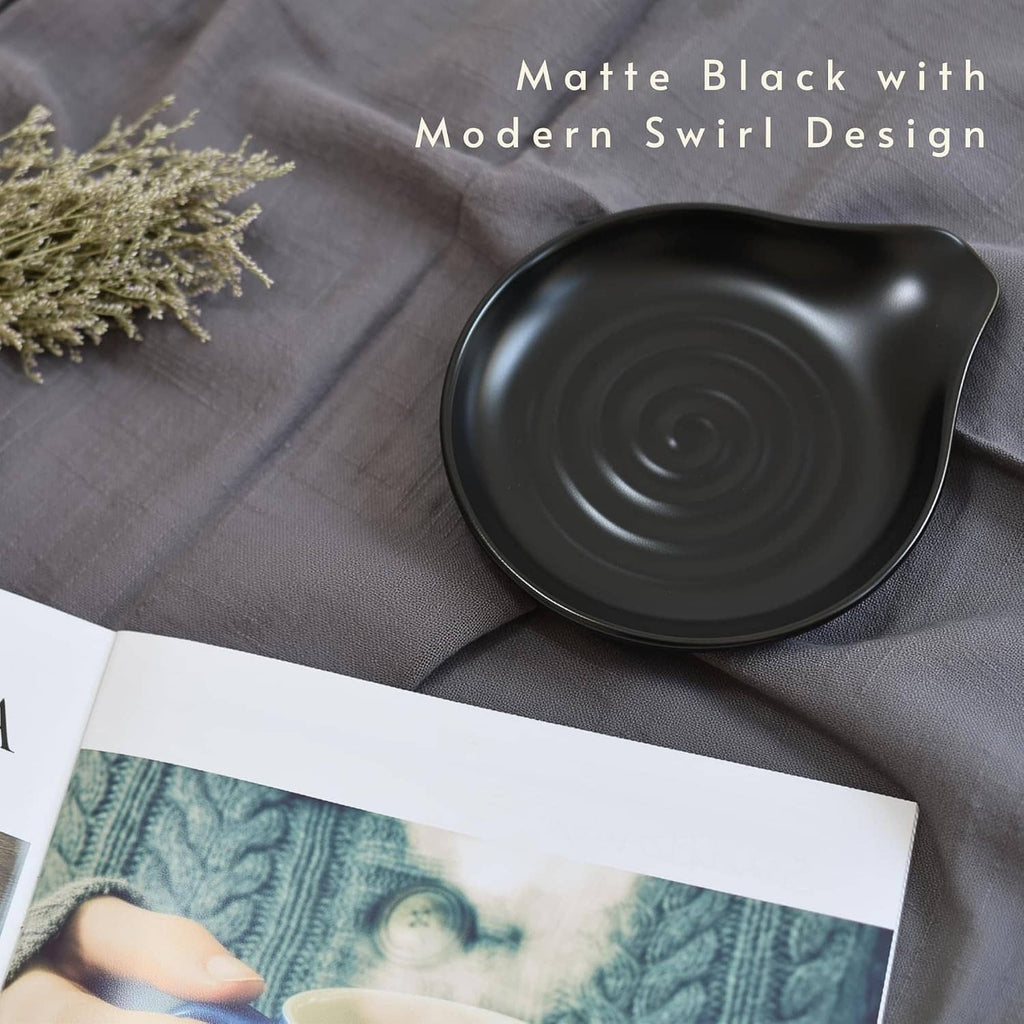 Matte black ceramic spoon rest with modern spiral swirl design