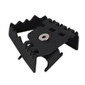 Rear brake extension pedal bracket in matte black with central bolt hole and serrated edges