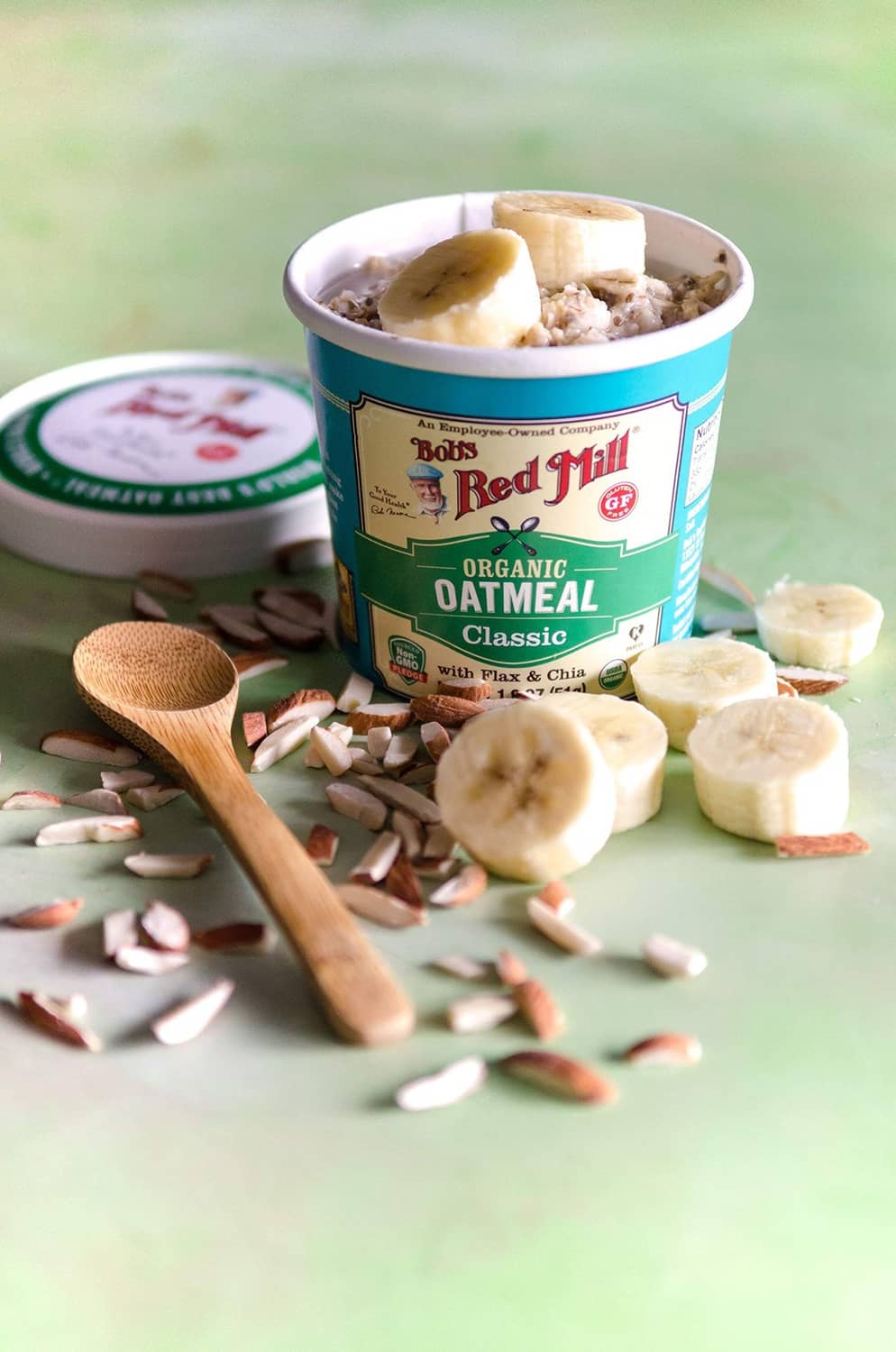 Bob's Red Mill Organic Oatmeal Classic cup with banana slices and oats nearby