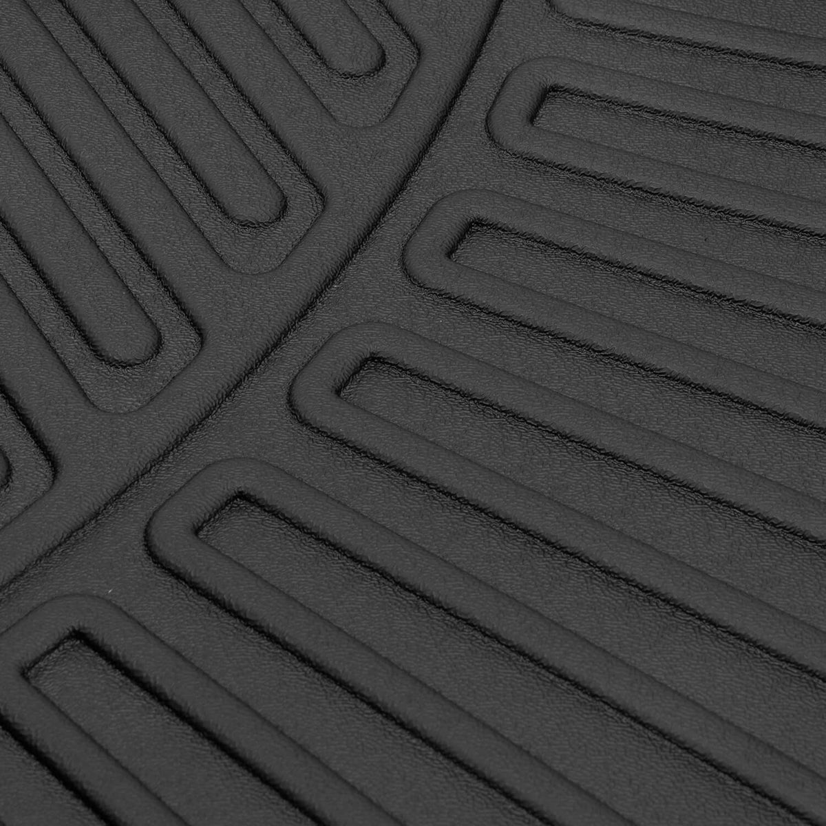 Molded floor mat surface with deep ribbed traction channels