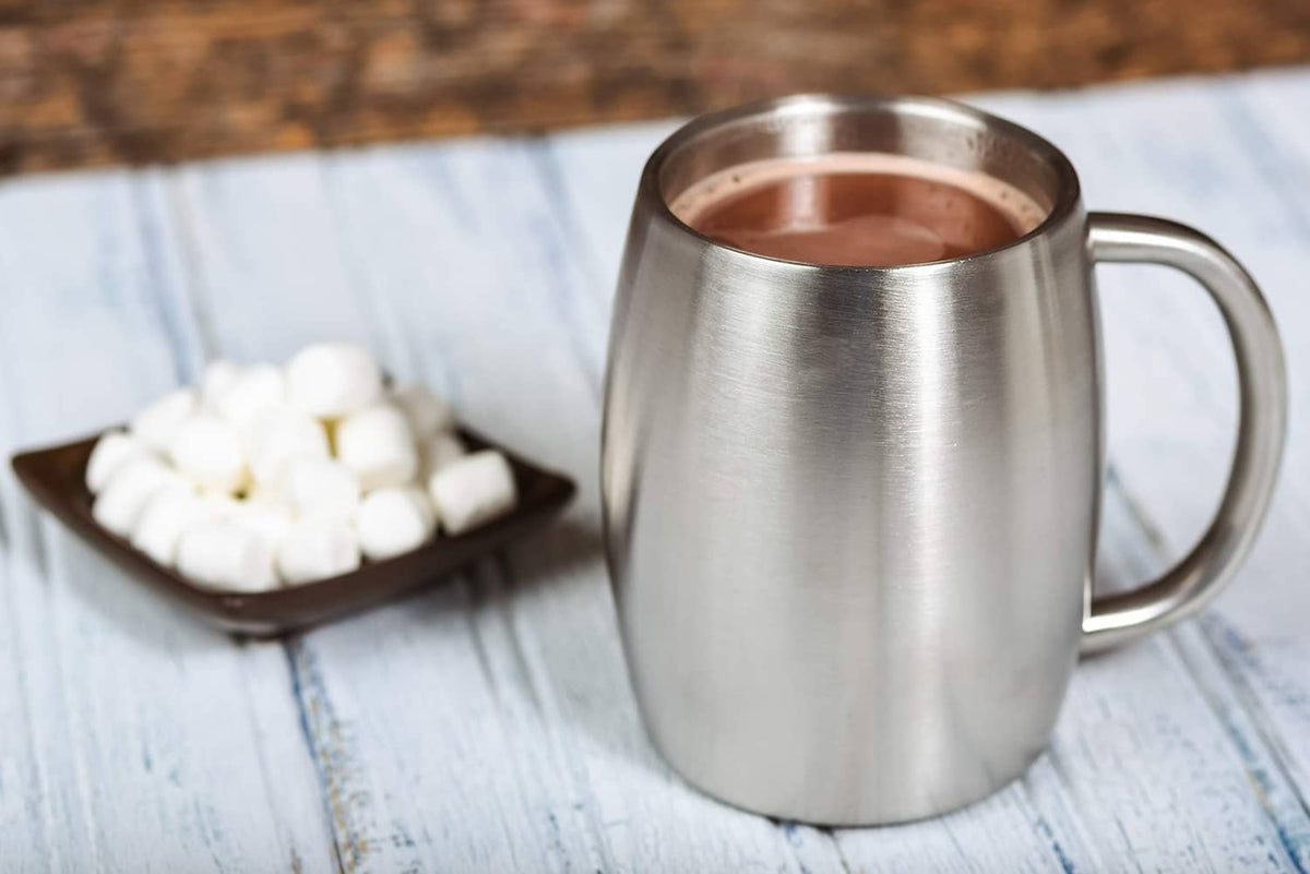 Stainless steel insulated coffee mug with handle filled with hot coffee