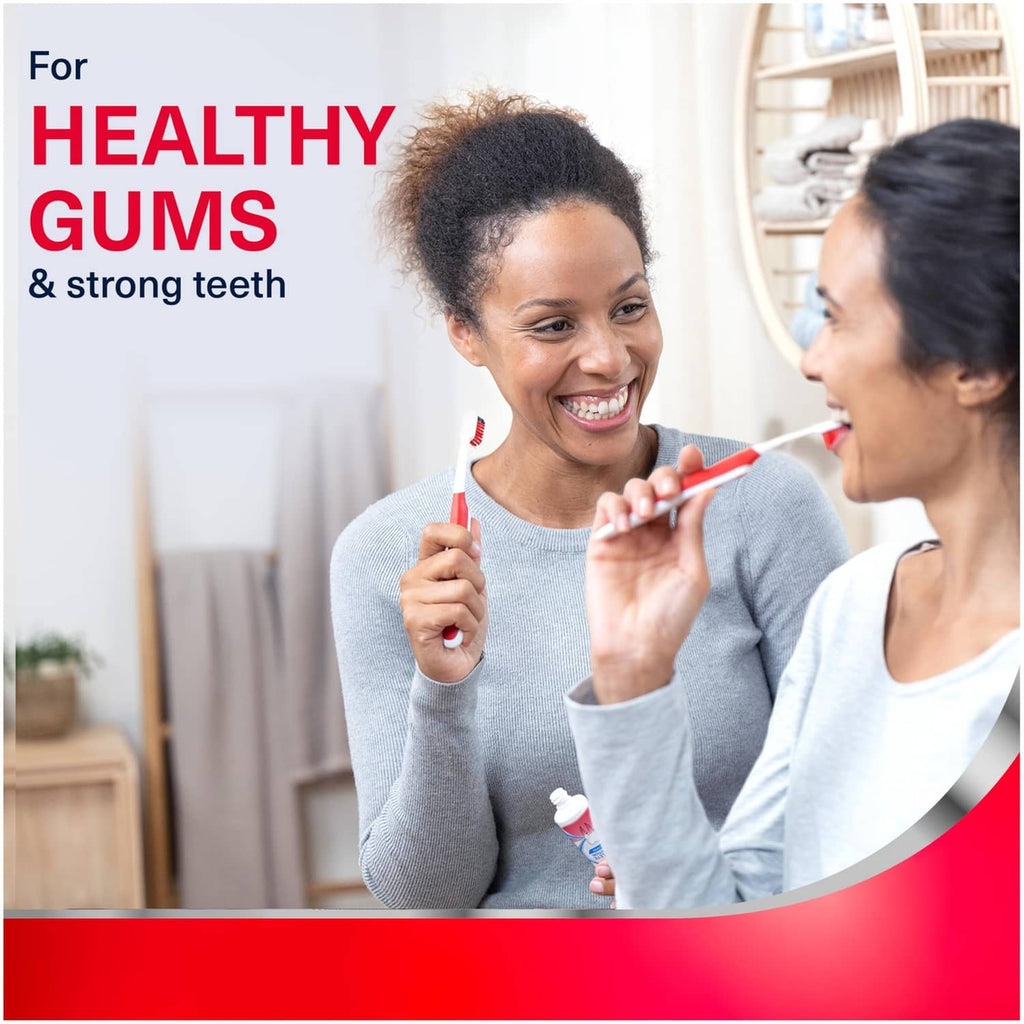 Person brushing with mint toothpaste, labeled for healthy gums and strong teeth