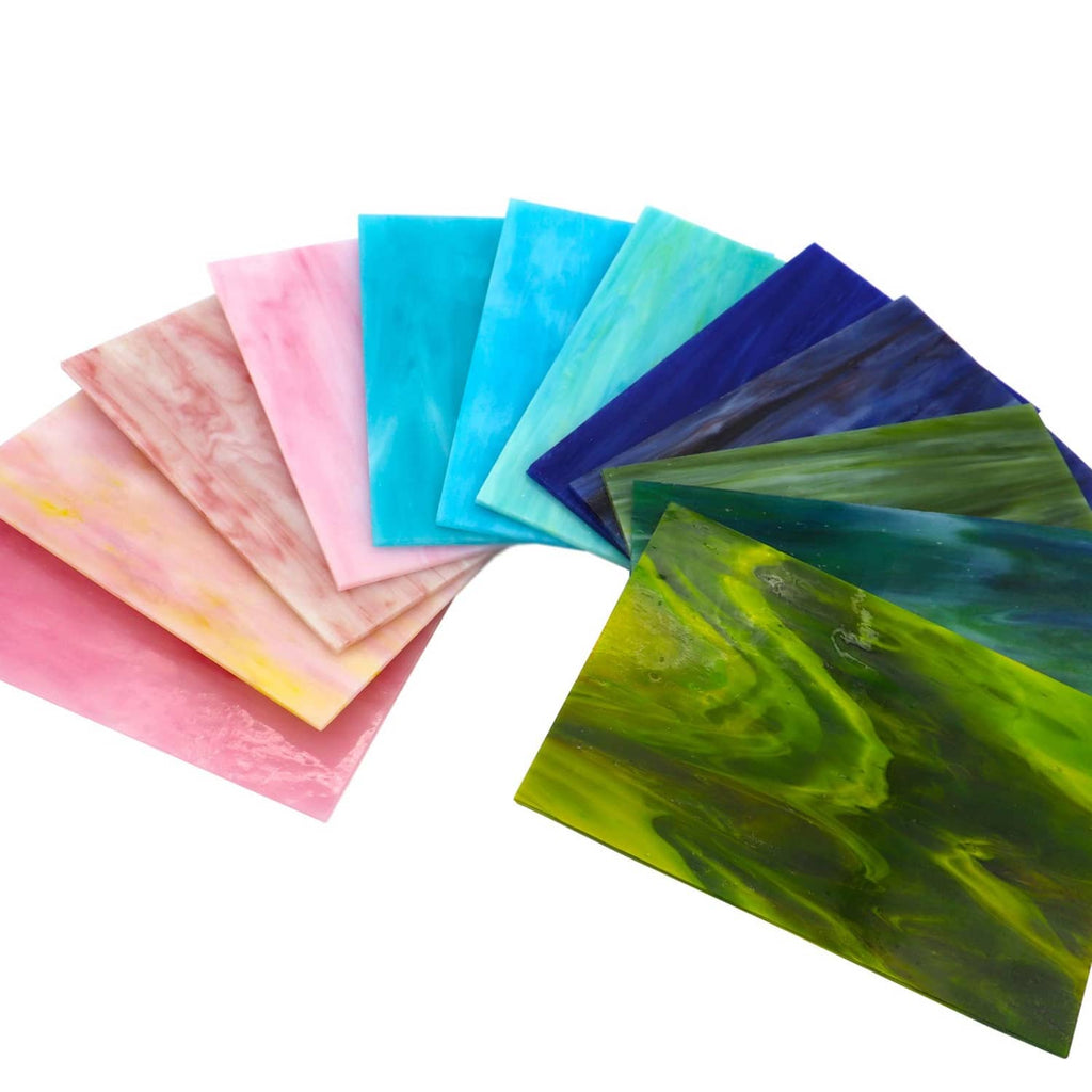 Fanned stained glass mosaic sheets in pink, aqua, green, and deep blue
