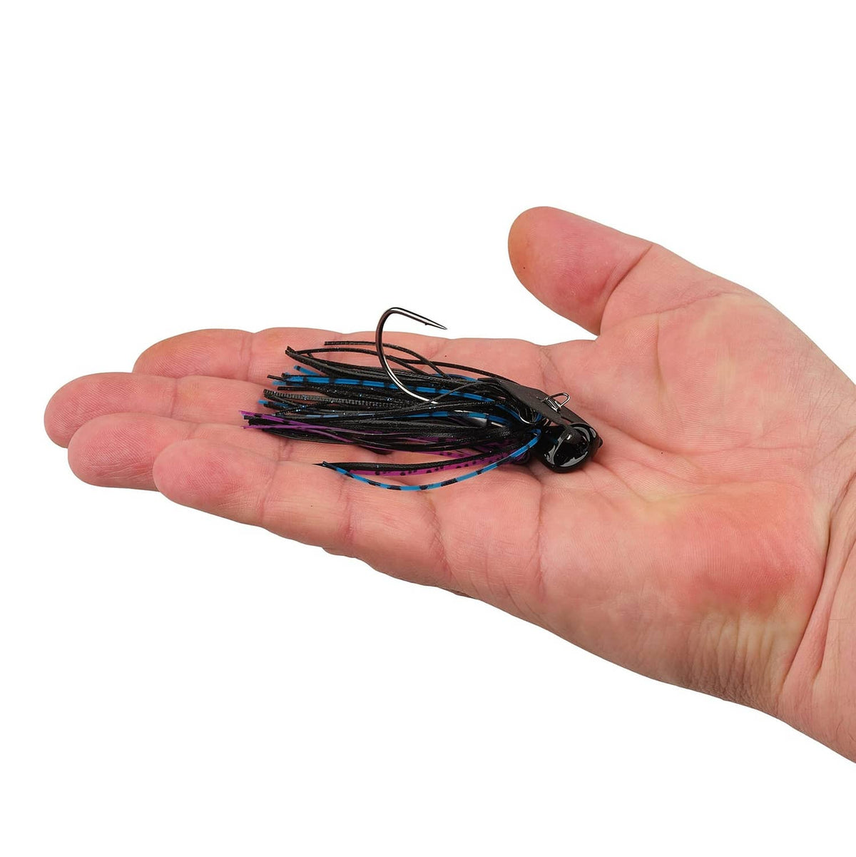 Black bladed jig with blue and purple skirt held in open hand