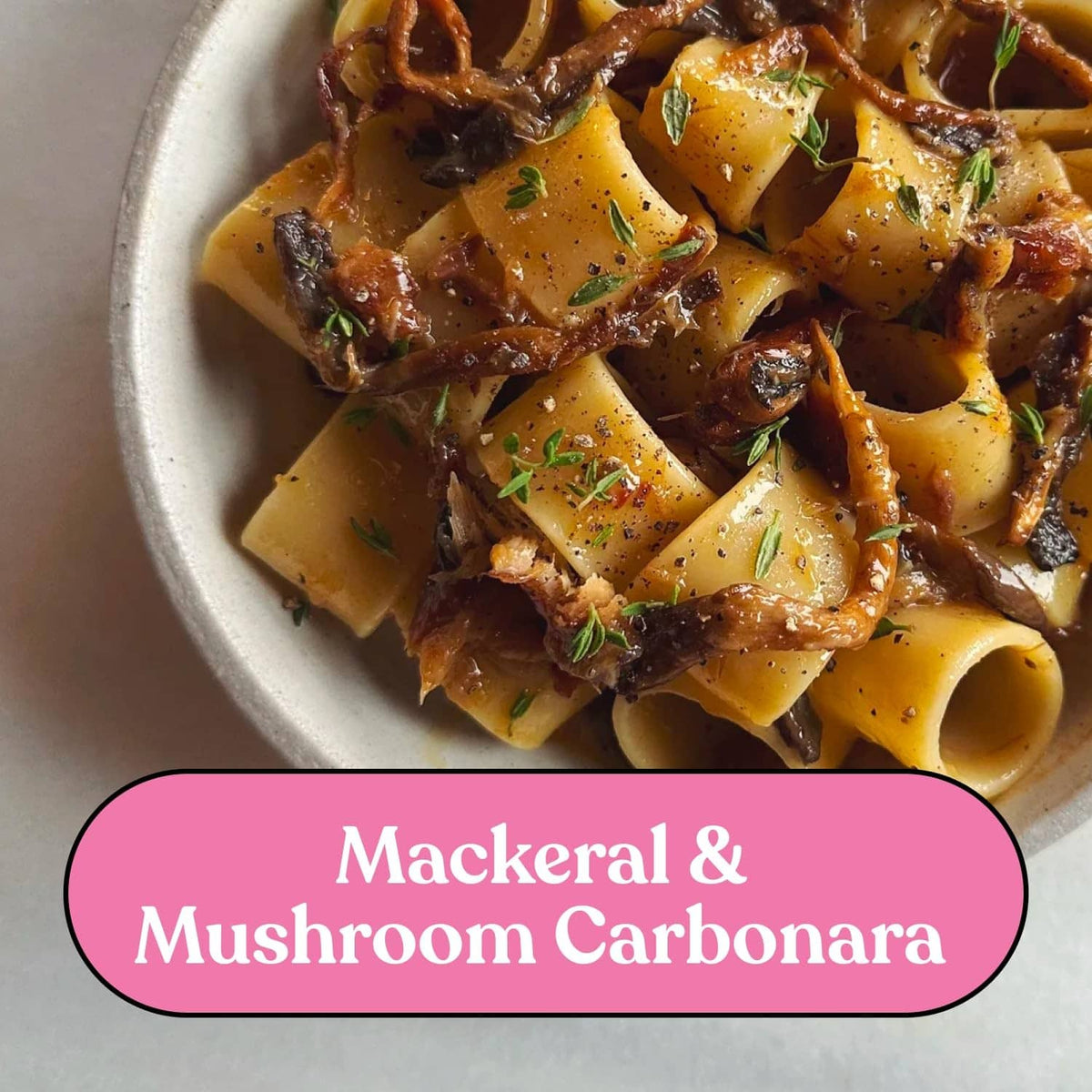 Smoked fish pasta carbonara served in a bowl with herbs and black pepper