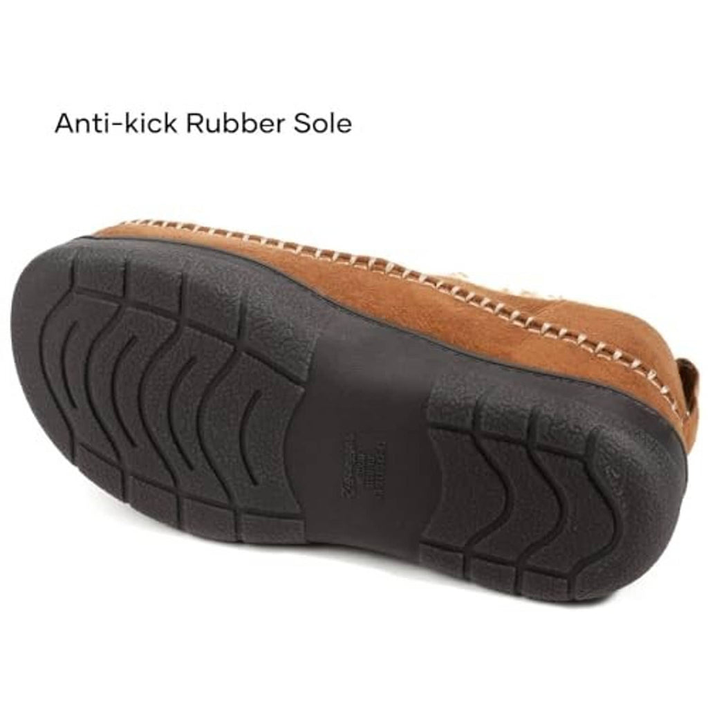 Tan moccasin slipper outsole view with dark anti-slip rubber tread and stitched upper edge.
