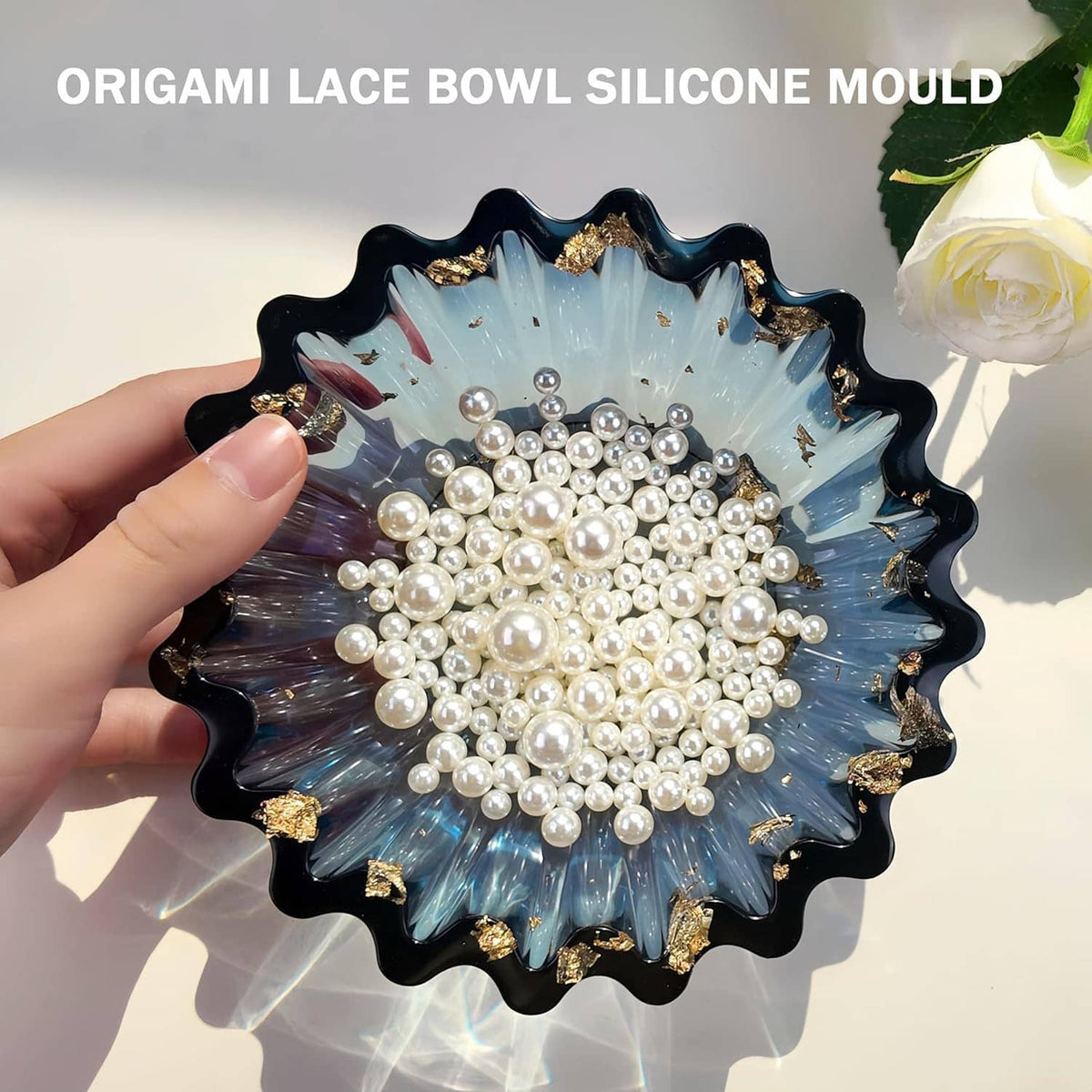 Black resin bowl with blue petal shape, gold rim accents, filled with pearl beads