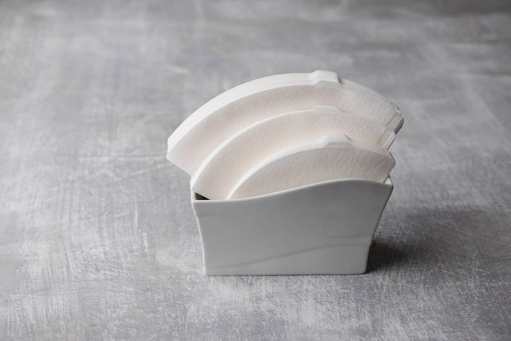 Folded white V60 size 02 paper coffee filters, nested