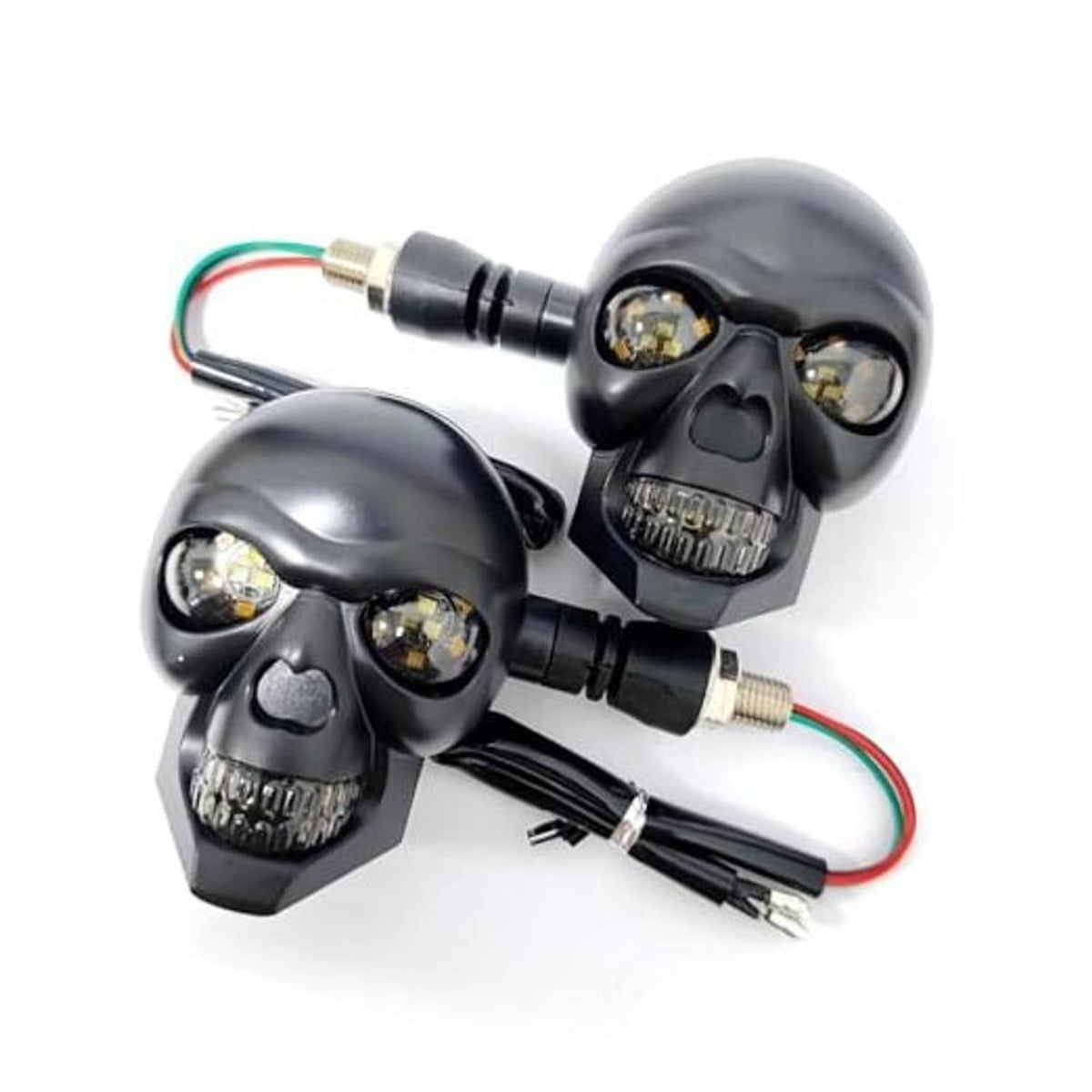Pair of black skull-shaped LED motorcycle turn signal lights with wiring harness