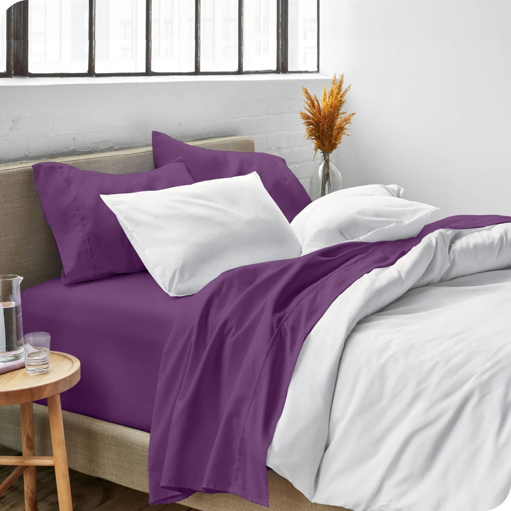 Plum and white twin bed sheet set with two white pillowcases and purple top sheet