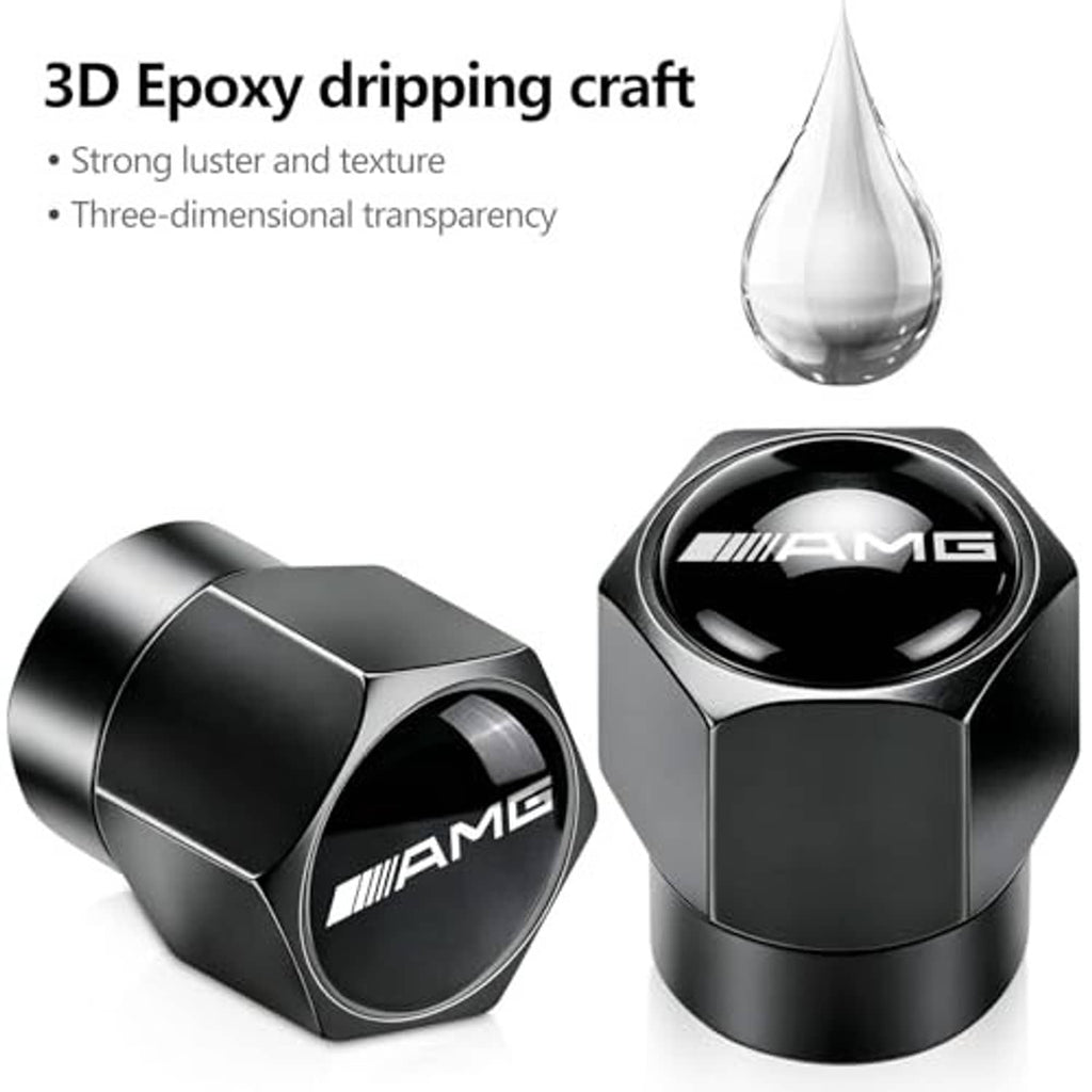 Black and silver metal tire valve stem caps with AMG emblem, angled view