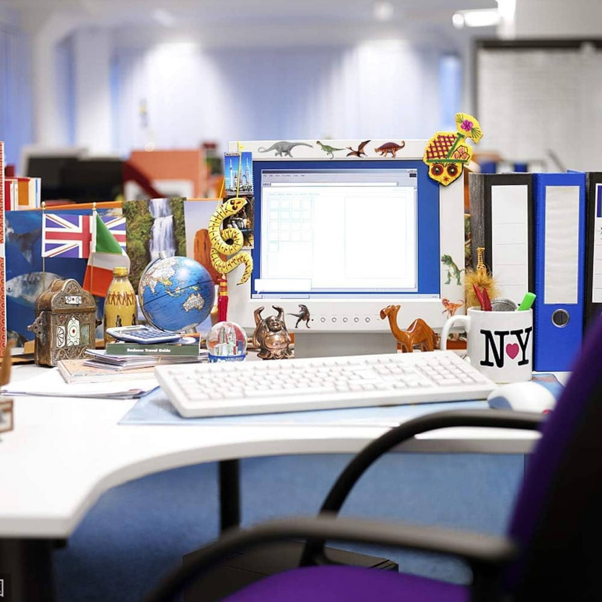 Colorful dinosaur stickers on office desk supplies and computer area