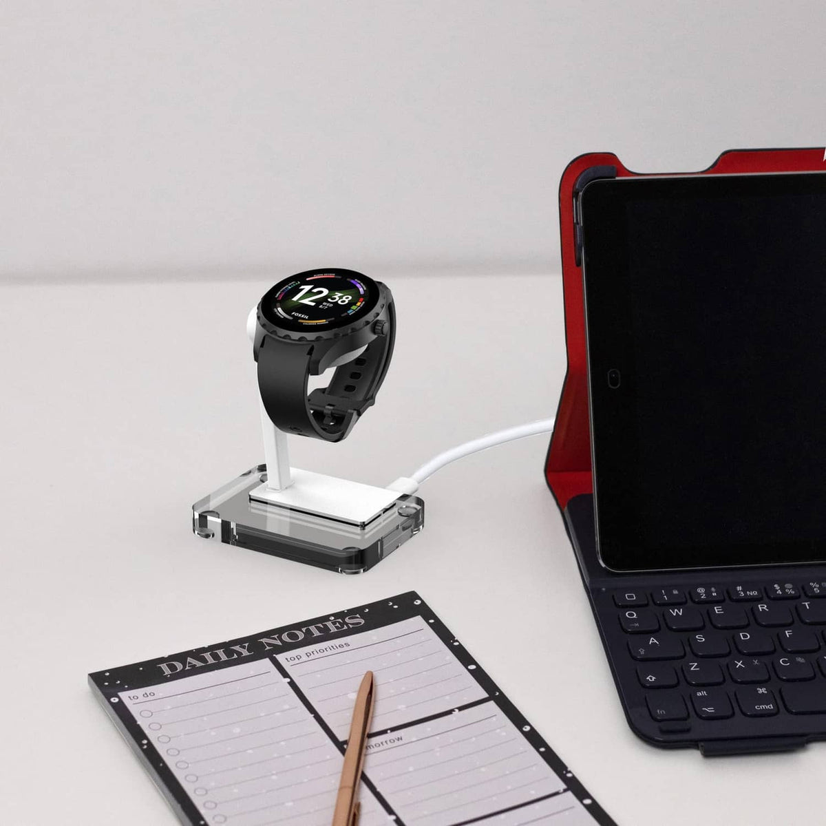 White and clear 4-pin smartwatch charging stand with cable connected.