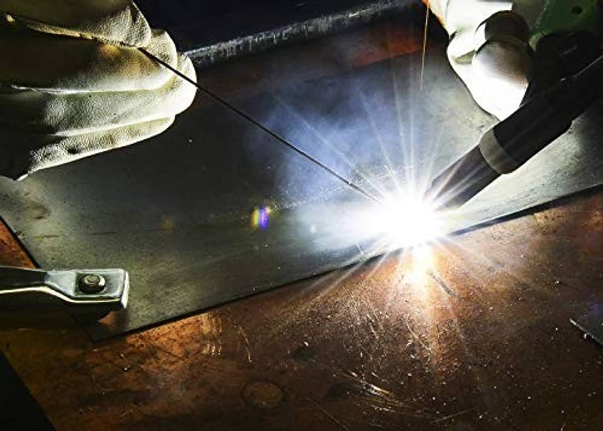 Metal welding arc with protective gloves and torch tip