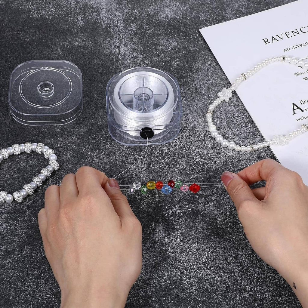 White elastic string used to assemble pearl and bead bracelets on flat surface