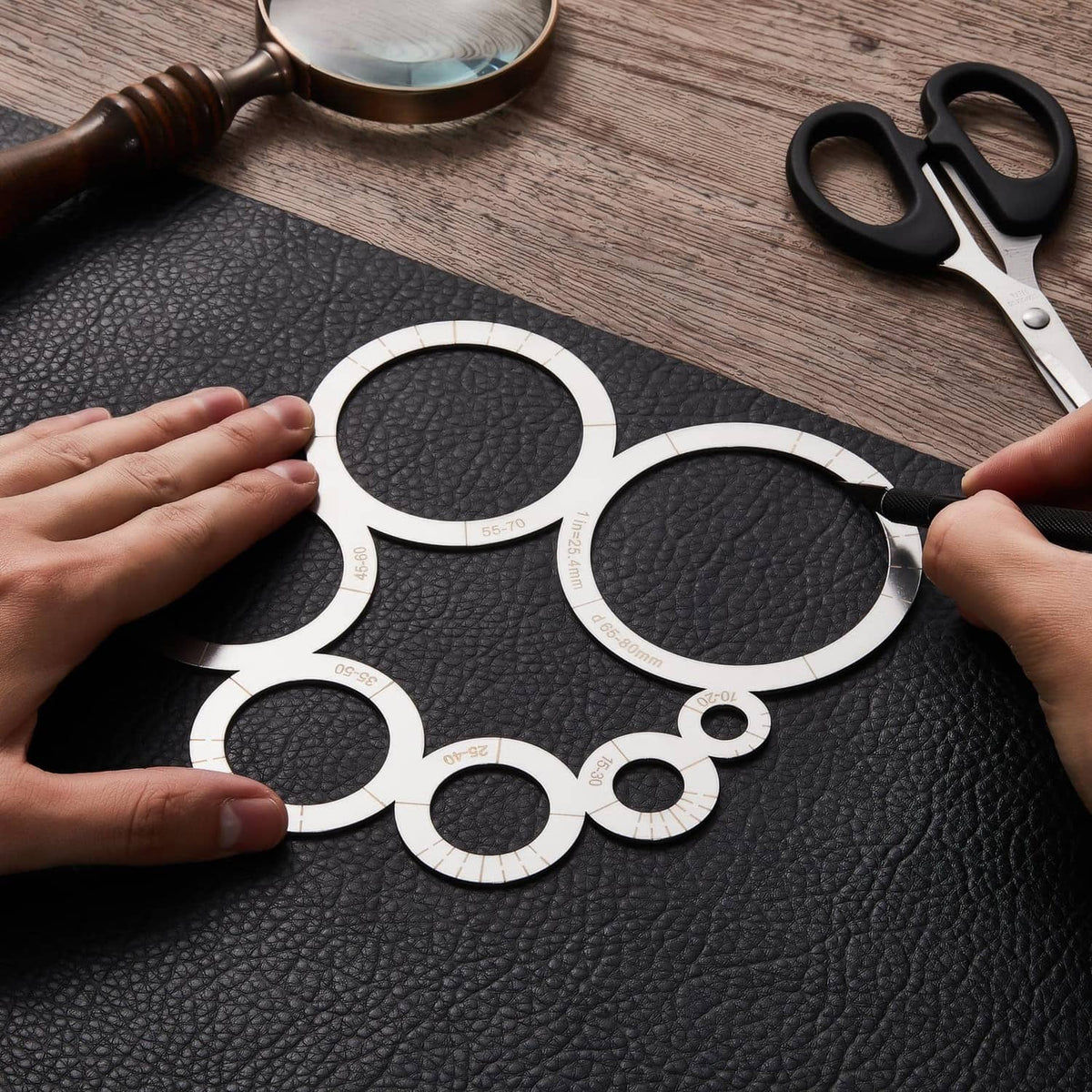 Round leather corner punch templates set on dark leather, white measuring rings for corner cuts