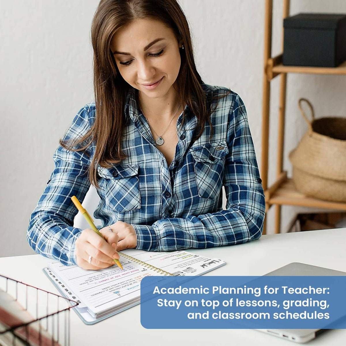 Woman writing in an open planner on a desk with weekly pages visible