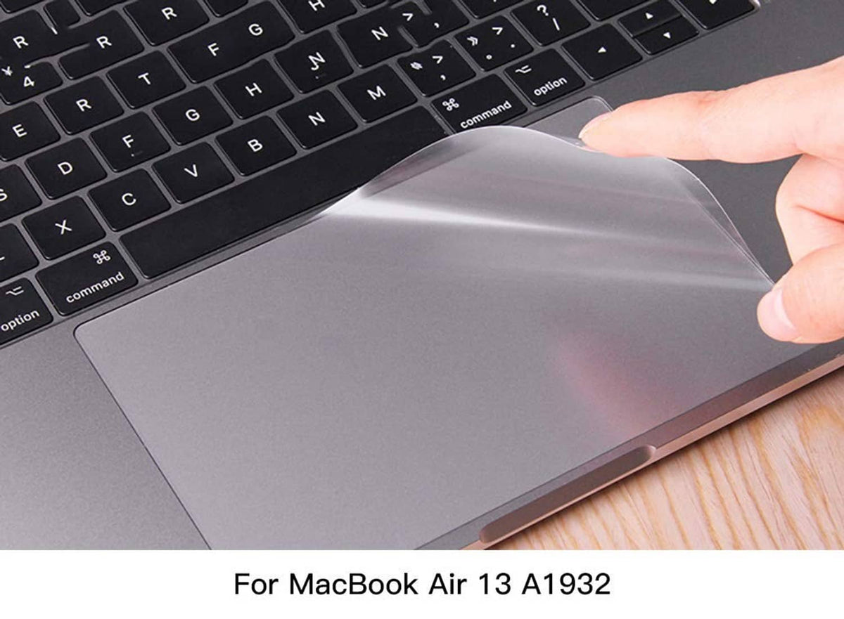 Clear trackpad protector film being smoothed onto the MacBook trackpad, transparent cover.