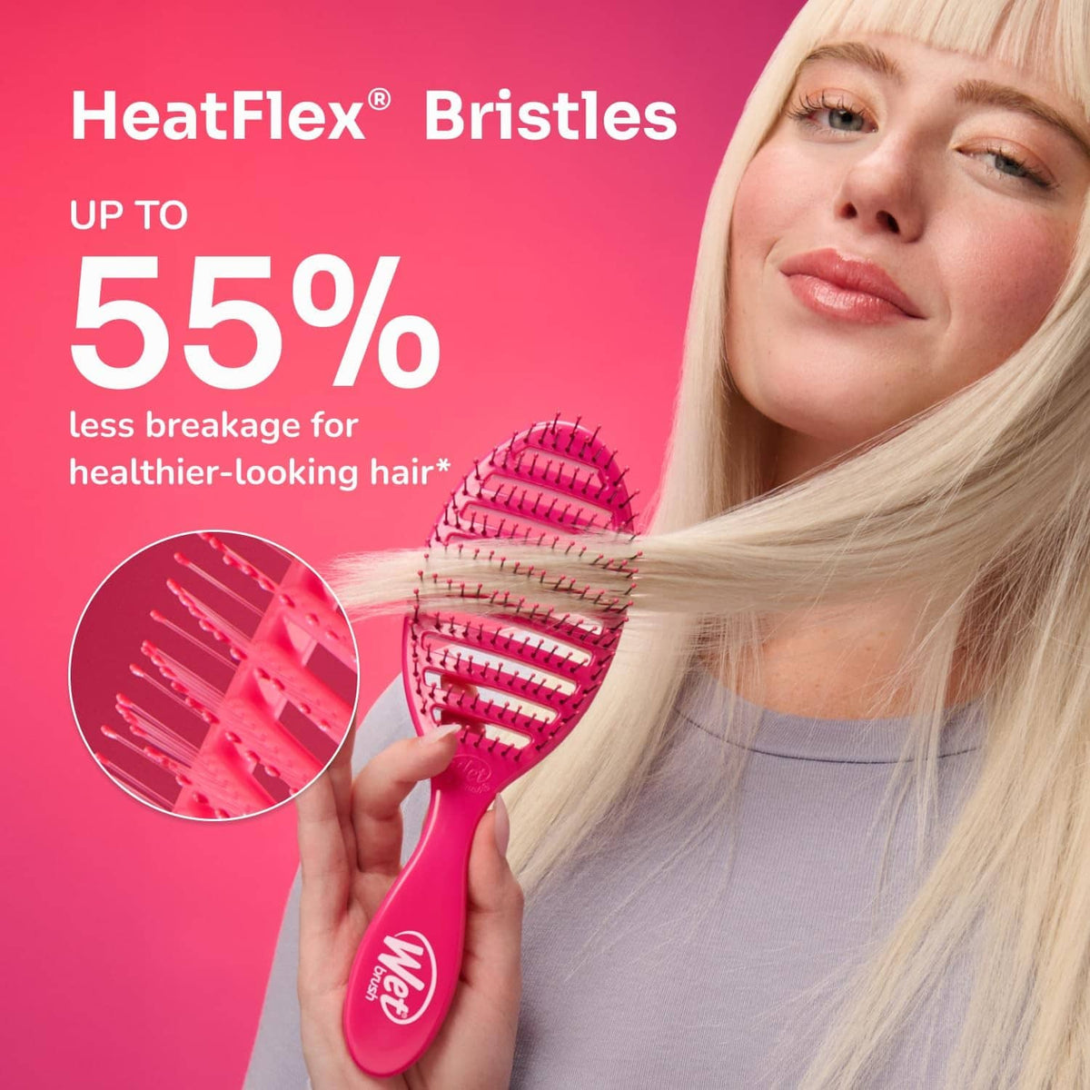 Pink HeatFlex bristle paddle hairbrush held near blonde hair