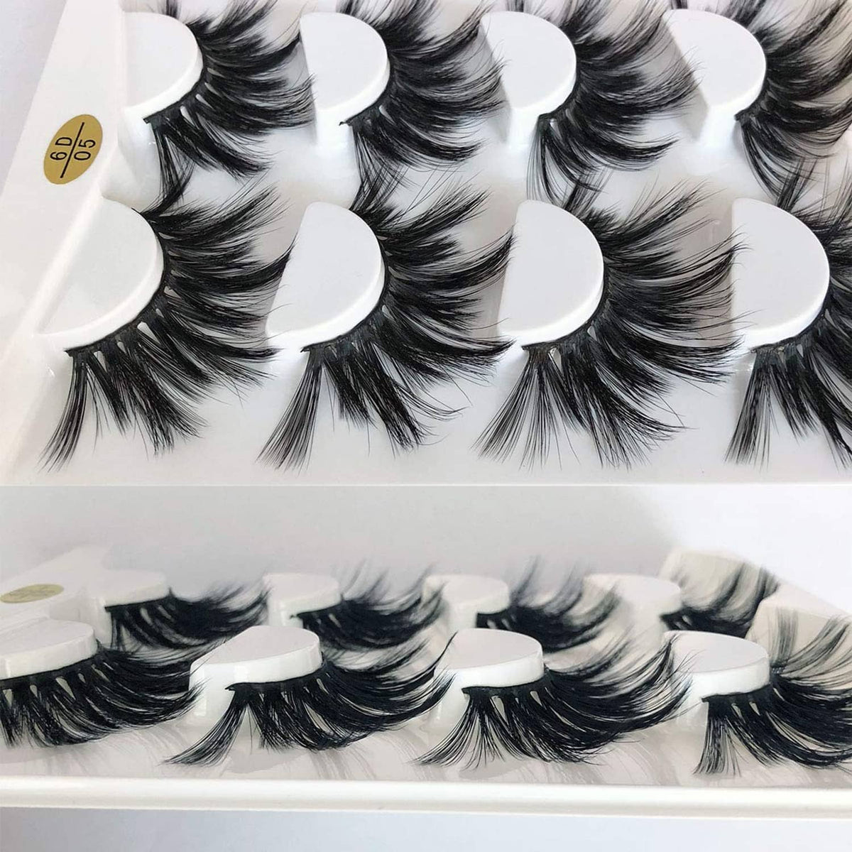 Dramatic faux mink false eyelashes with multiple fluffy black clusters, tray view