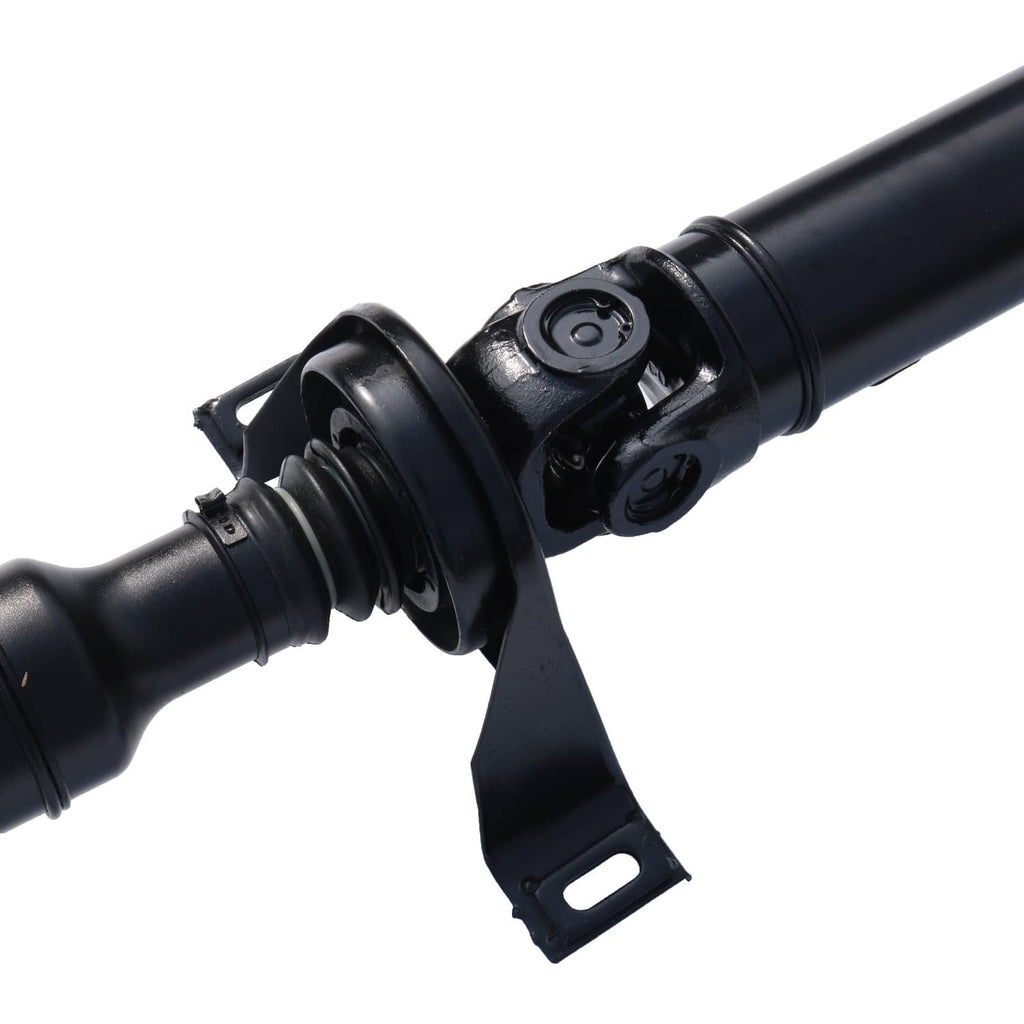 Close-up of black drive prop shaft joint with rubber boot and bracket mount