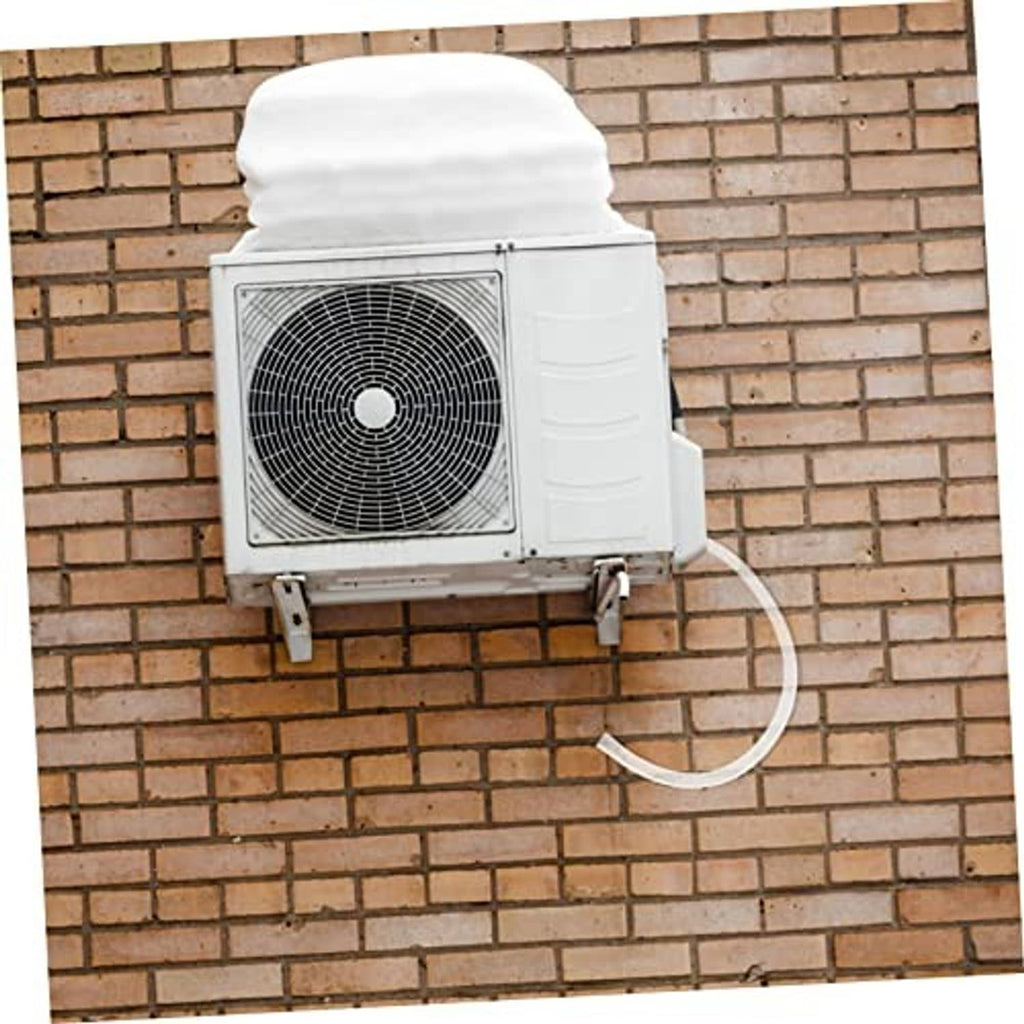Air conditioner drain hose kit with white tube connected to outdoor AC unit