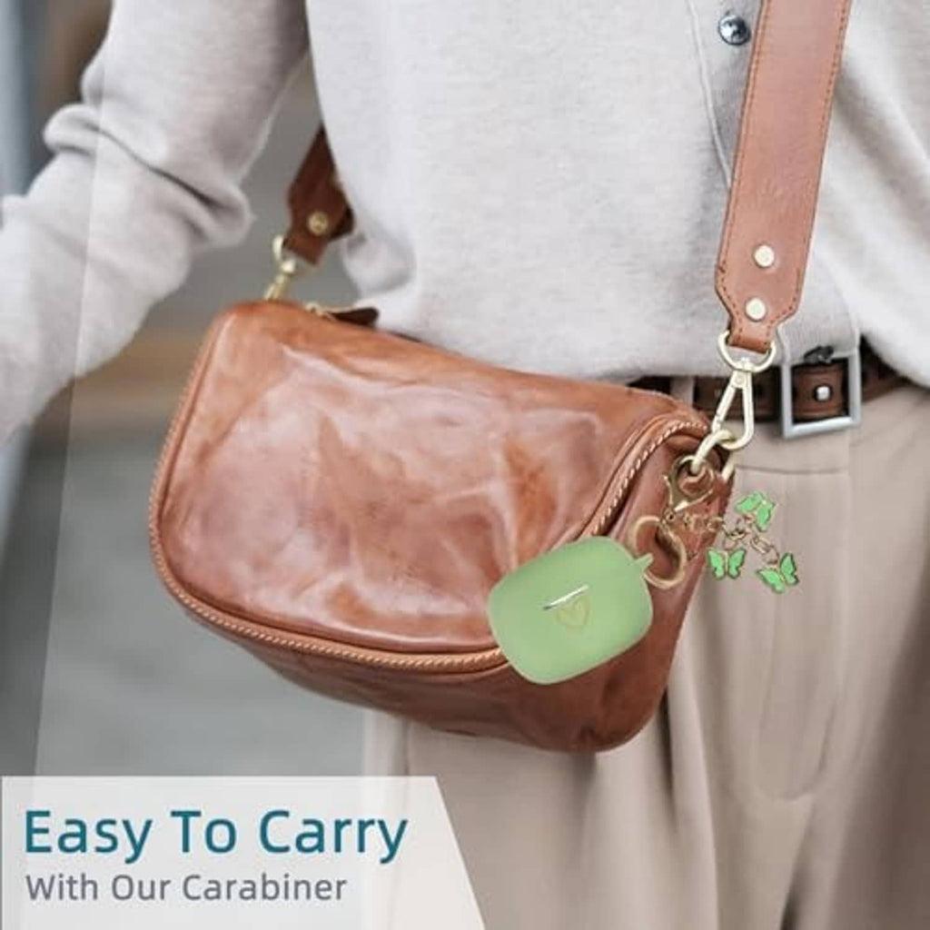 Matcha green silicone earbud case cover clipped to a bag strap with carabiner