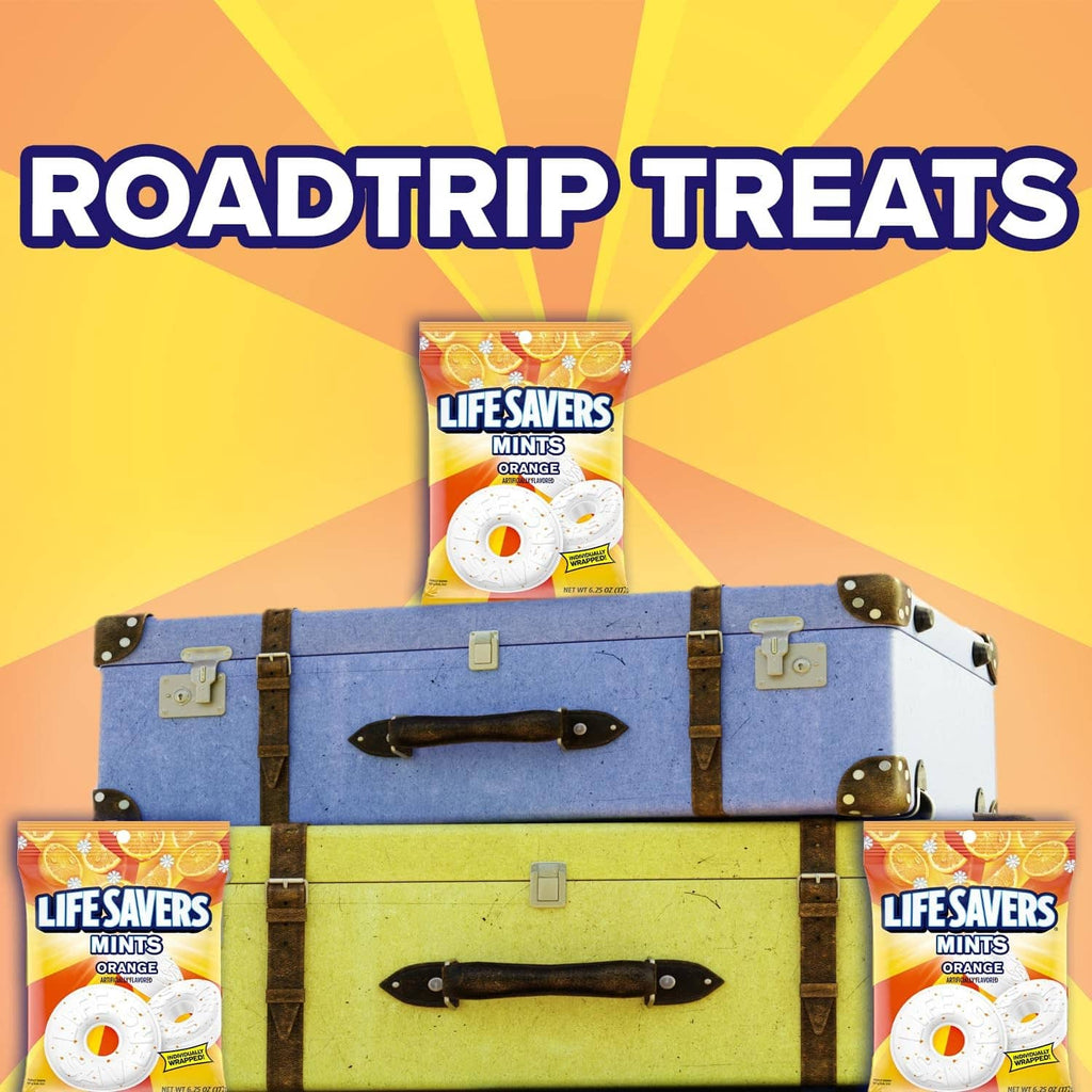 Orange-flavored mint candy bags with white donut mints, shown around a suitcase