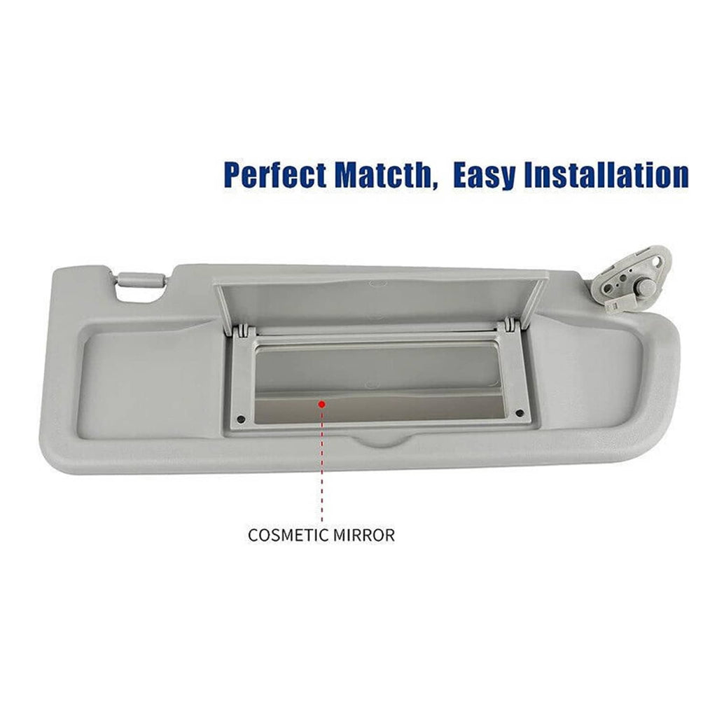 Gray sun visor with vanity mirror door and warning label panel.