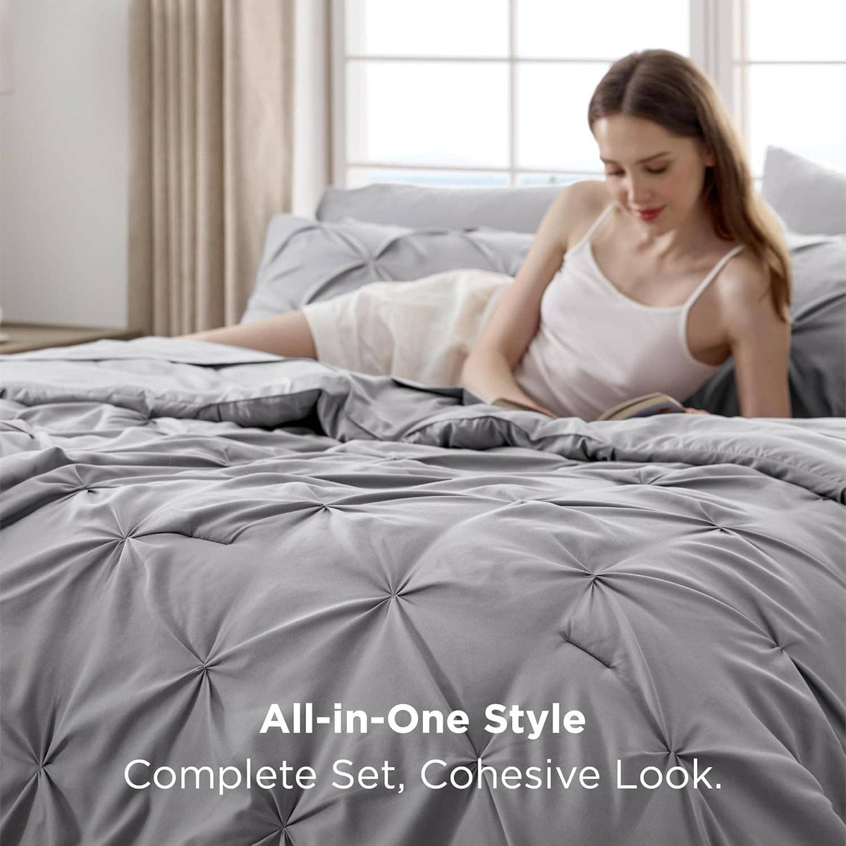 Grey pinch-pleat all-in-one style bedding set on a queen bed
