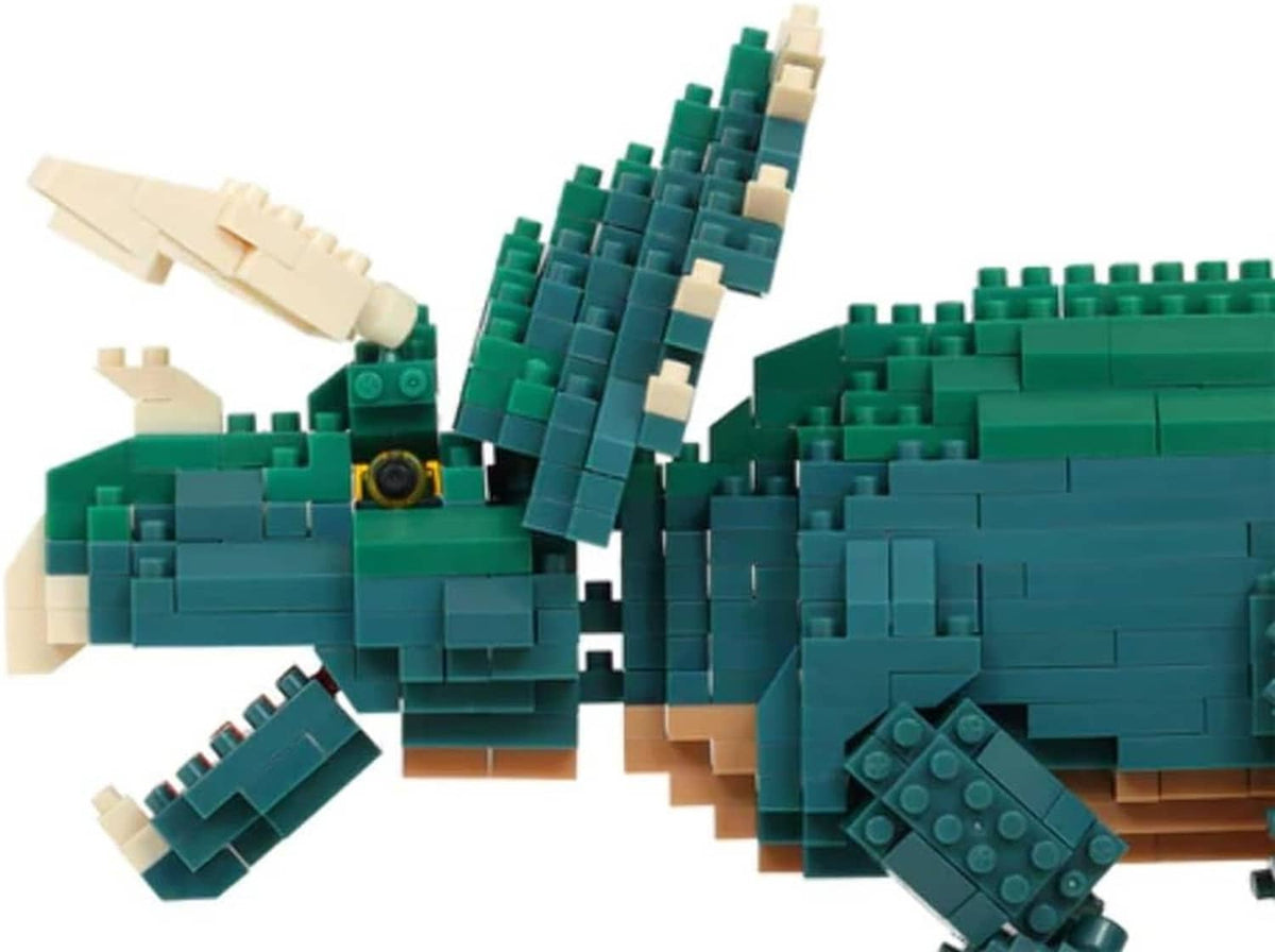 Close-up of Triceratops dinosaur block model with teal-green armor plates and beige spikes