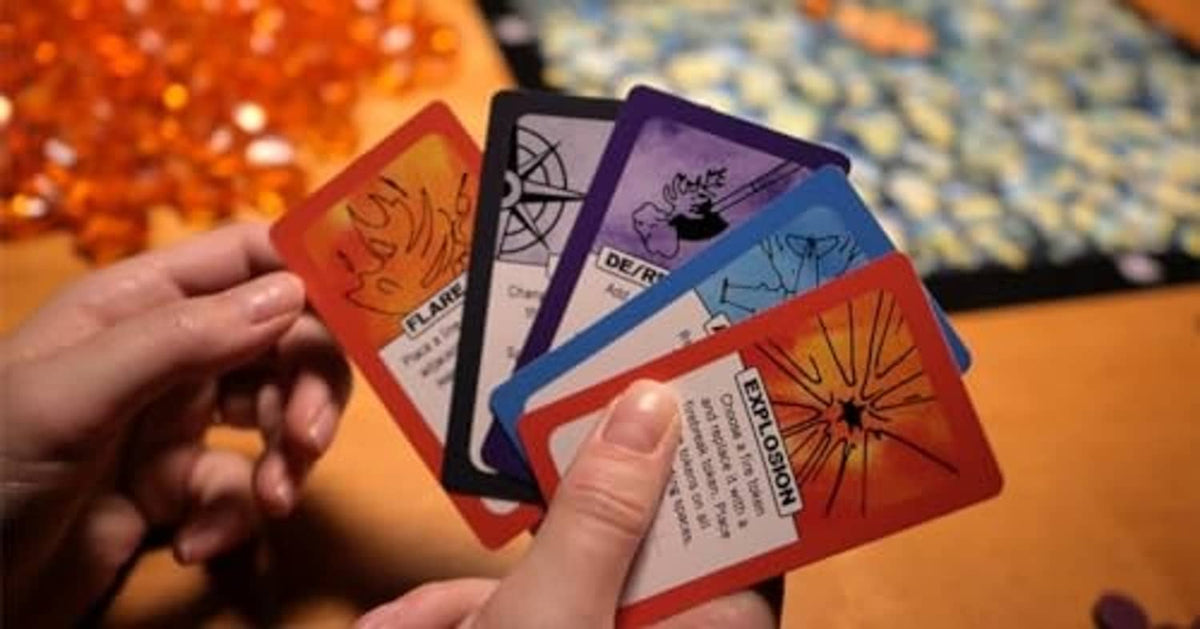 Hand holding Fire Tower cards with fire and diagram illustrations
