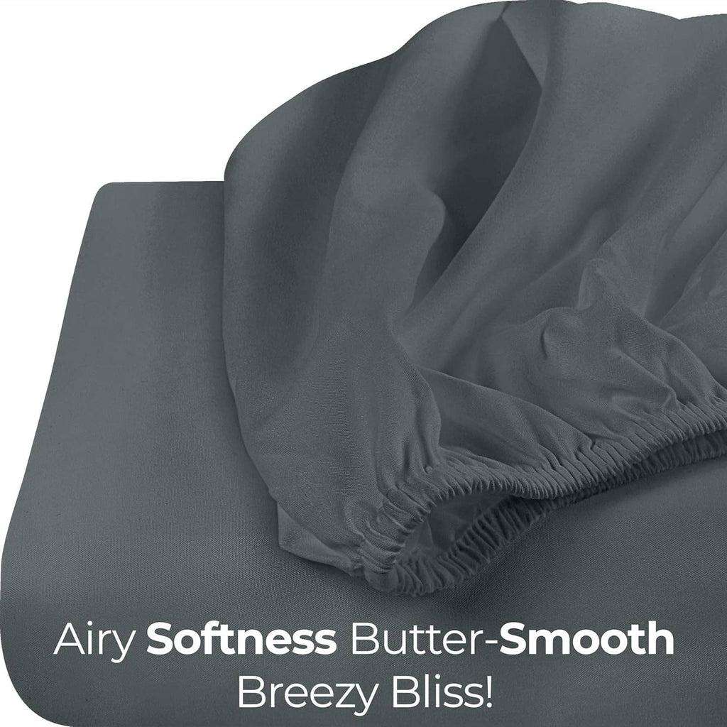 Dark gray fitted sheet fabric folds with smooth, airy-soft drape