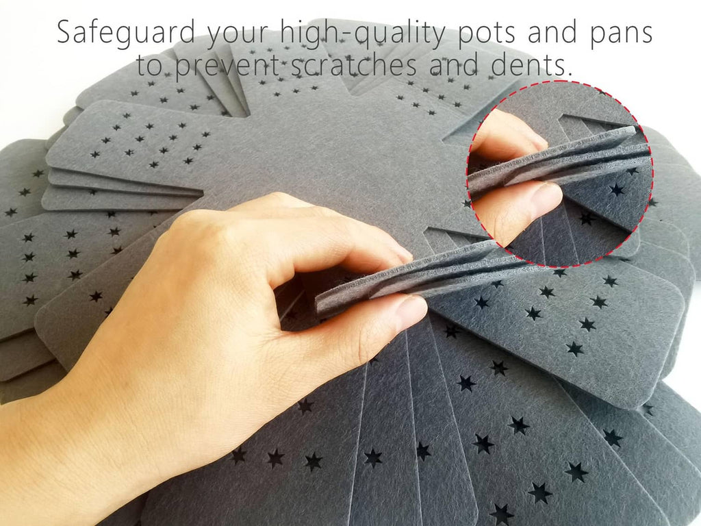 Gray pot and pan protectors with star-dot holes beneath a hand placing cookware.