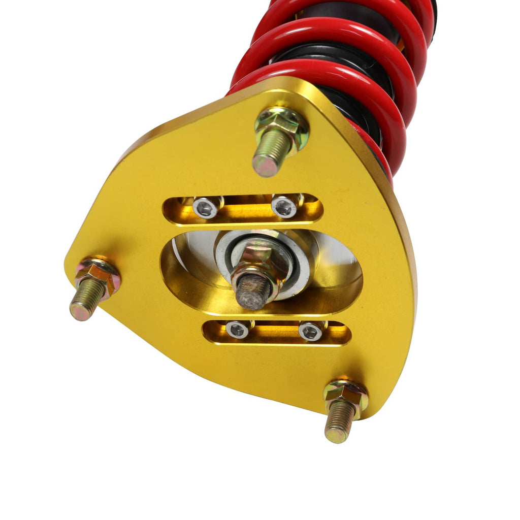 Close-up of gold coilover spring perch with red spring and mounting bolts