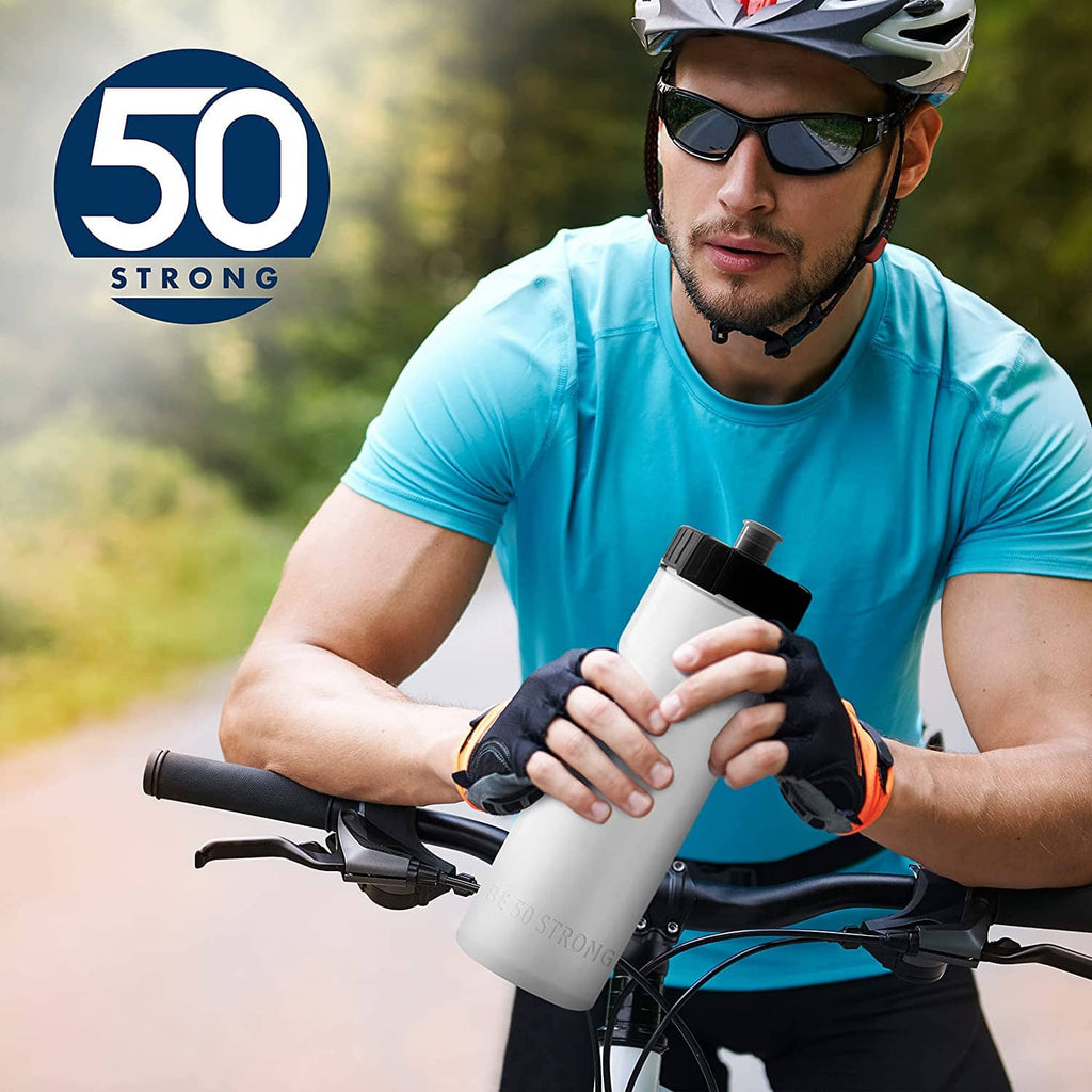 Hand holding blue 22 oz sports water bottle with black cap, 50 Strong logo