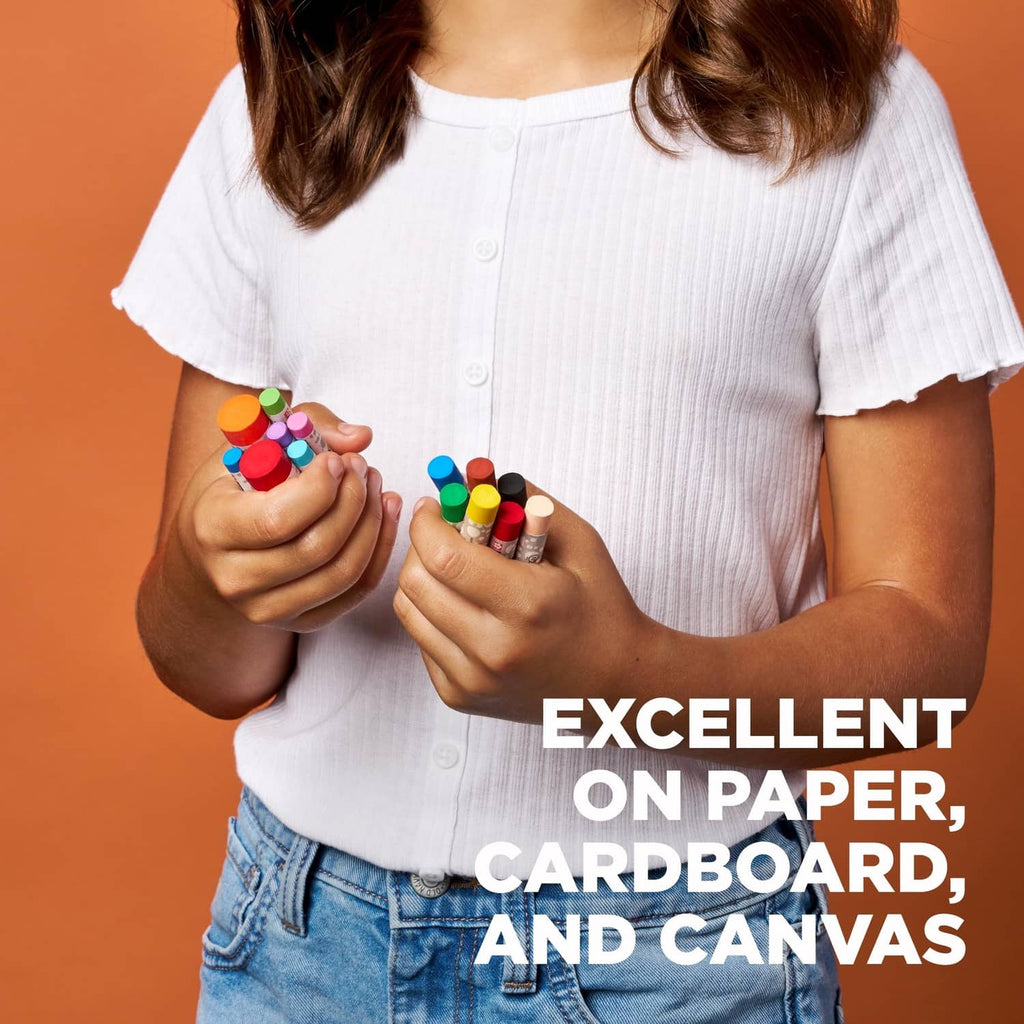 Oil pastel crayons, child holding colorful crayon sticks in small hands