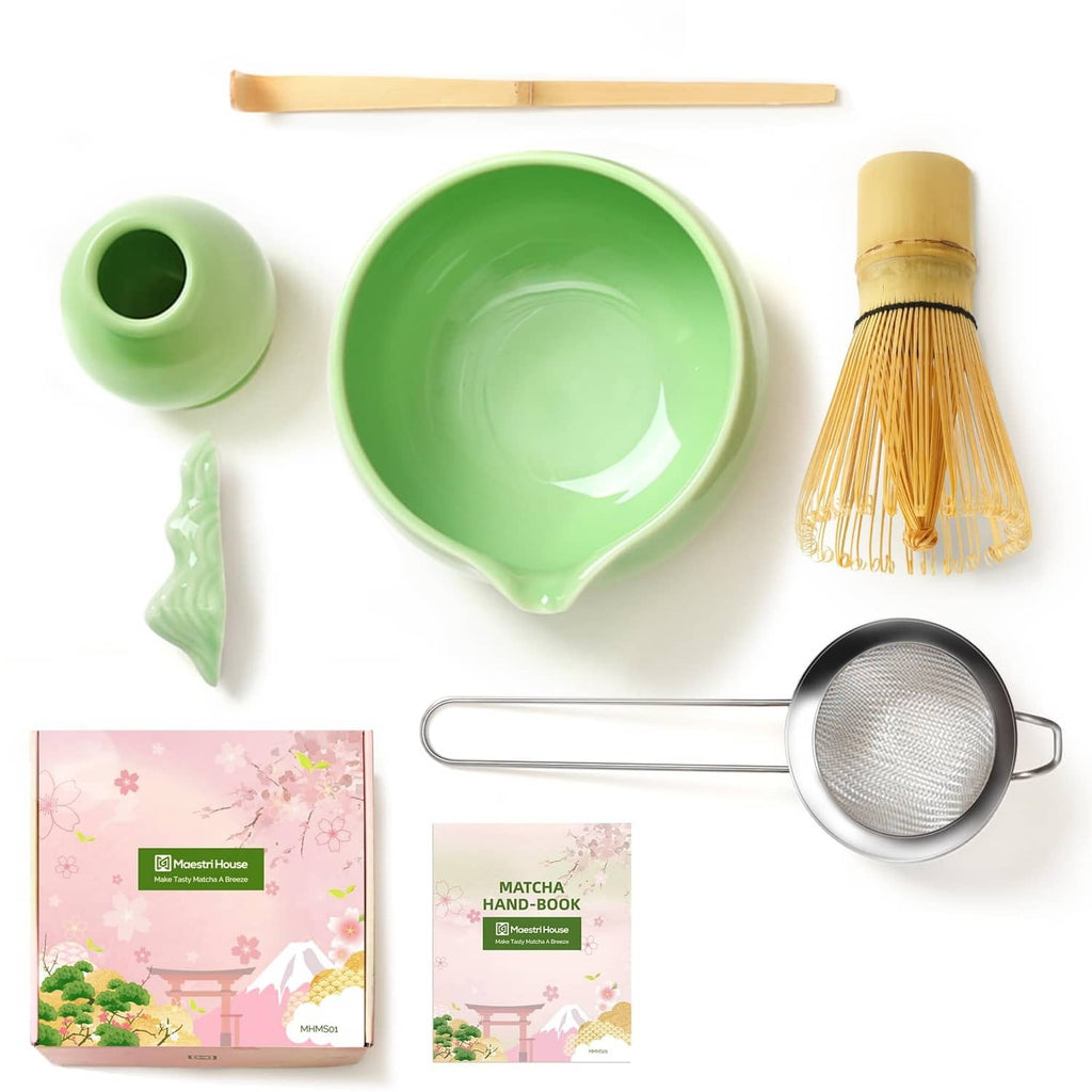 Green matcha whisk set flat lay with bowl, sifter strainer, whisk brush and instruction books