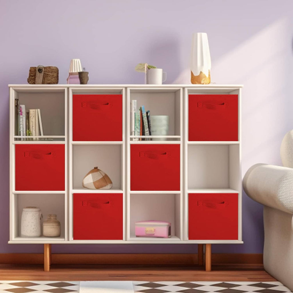 Red fabric storage cube bins with front handles inside an open shelf unit