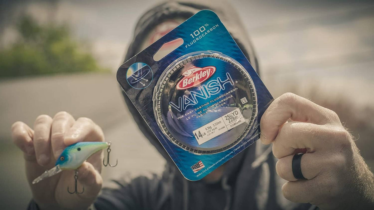 Berkley Vanish clear fluorocarbon fishing line spool pouch held in hand.