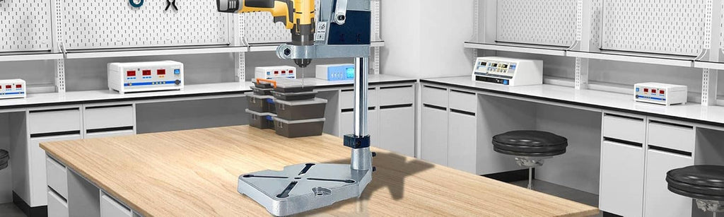 Drill press stand head on a blue column with a gray base plate on a workbench
