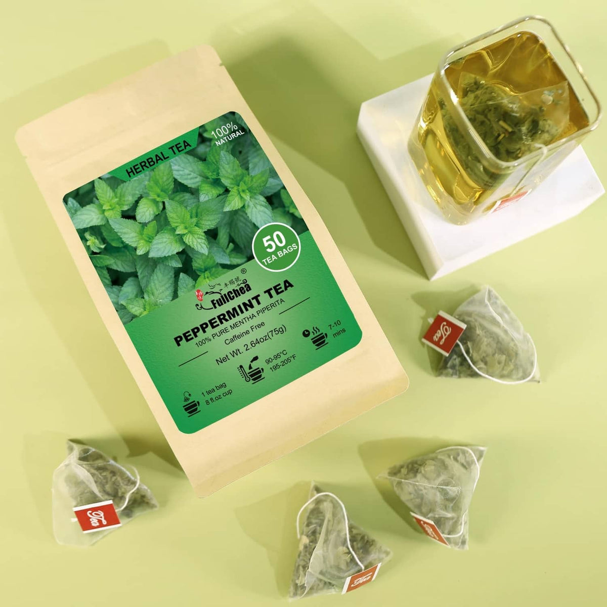 Peppermint tea bag pouch with several tea bag sachets and a glass cup of tea
